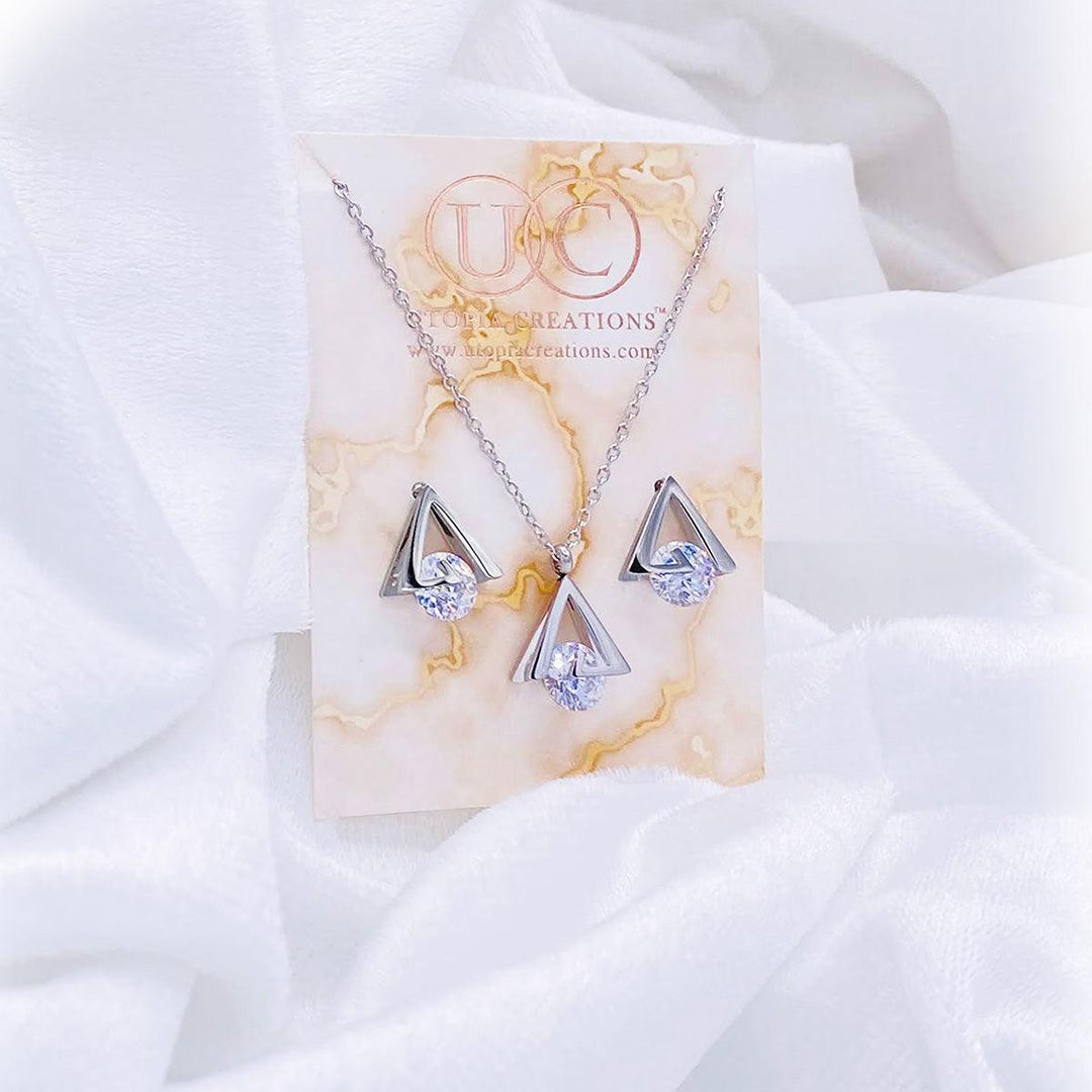 Stainless steel pyramid shaped earrings and necklace with simulated CZ stone. Available at Simply Greek by Utopia Creations