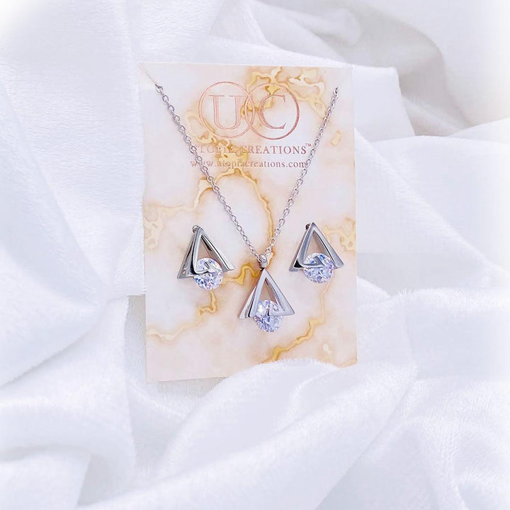 Stainless steel pyramid shaped earrings and necklace with simulated CZ stone. Available at Simply Greek by Utopia Creations